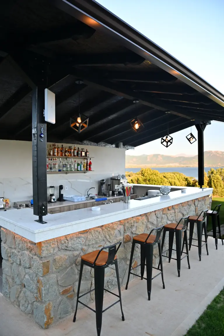 view of the stone outside bar of the hotel with a wooden roof and modern design
