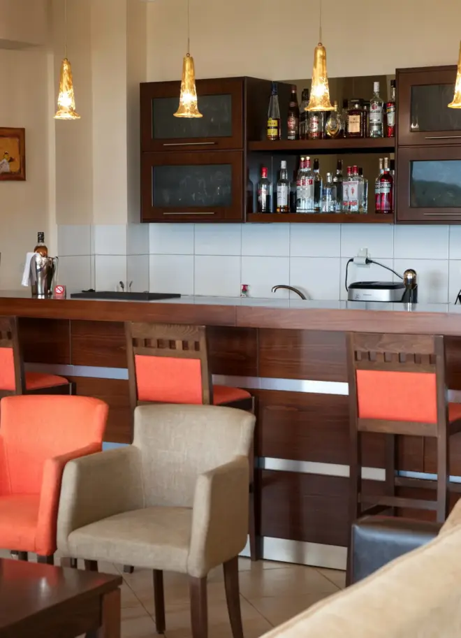 indoor lounge area of the hotel with modern furniture and a bar