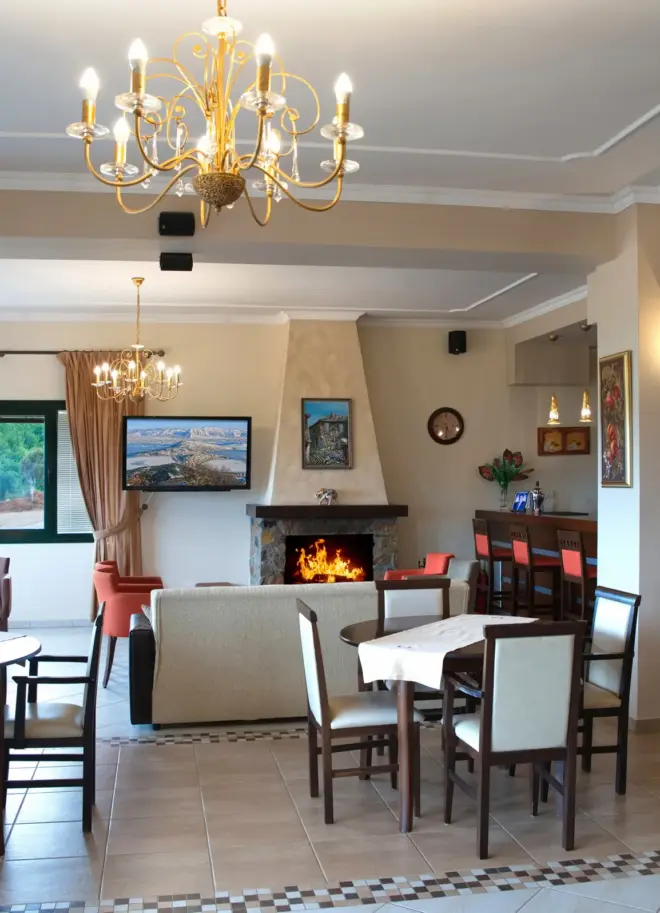 day view of the indoors lounge area with white wooden chairs and a chandelier