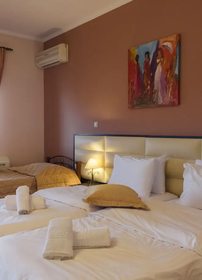 inside view of a hotel room featuring a double bed with luxurious bedsheets