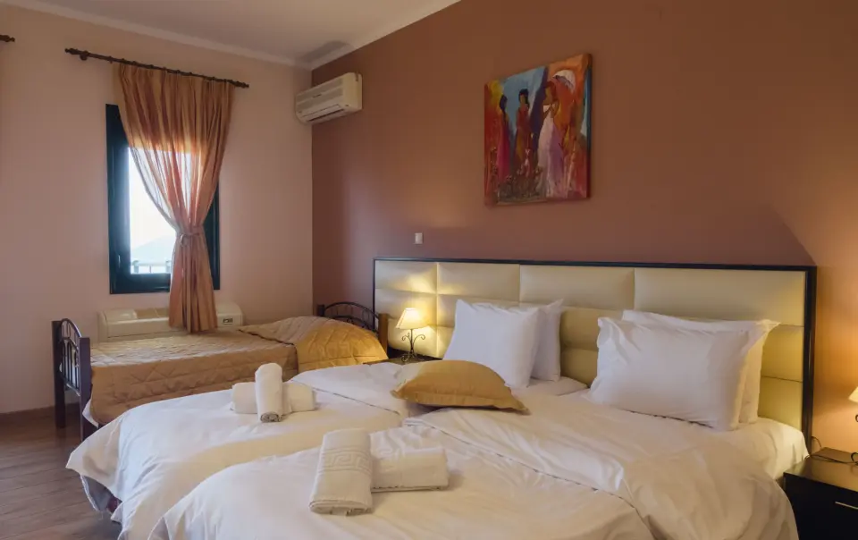 inside view of a hotel room featuring a double bed with luxurious bedsheets
