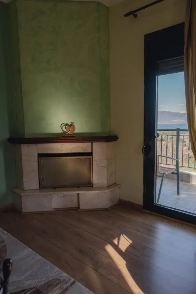 inside view of a hotel room featuring the corner fireplace