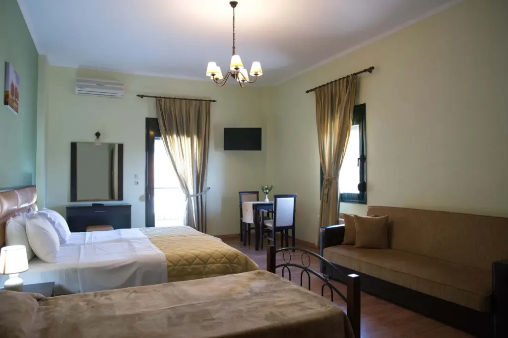 inside view of the hotel room featuring one double bed and one single bed
