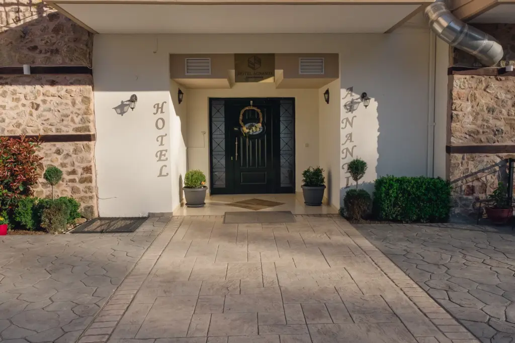 front view from the outside showcasing the main entrance of the hotel and the stone pathway to it