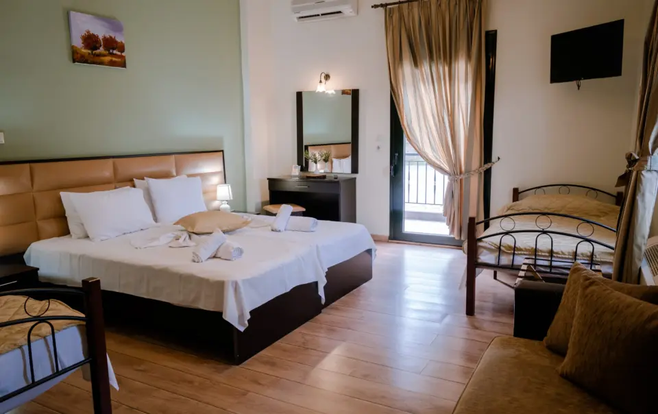 realistic photo of a hotel room featuring a large double bed with white sheets and various modern furniture around it